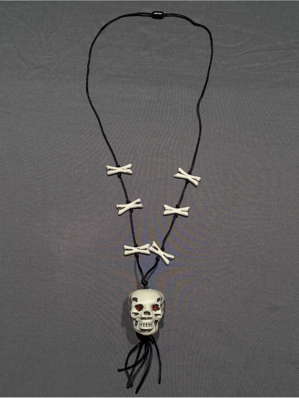Greenbrier International Plastic Skull and Crossbones Cord Necklace